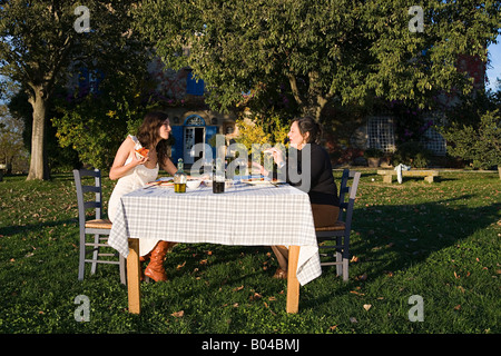 Mother and daughter having lunch in garden Stock Photo