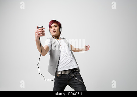 Japanese man listening to mp3 player Stock Photo