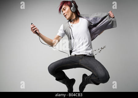 Japanese man listening to mp3 player Stock Photo