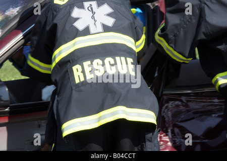 Several EMS workers rescueing a victim from a car accident Stock Photo