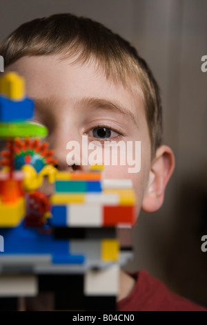 Boy looking over plastic blocks