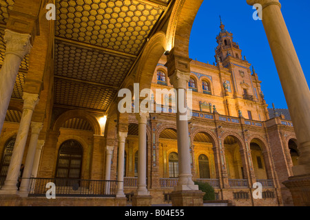 Arches and tower of the central building in the Plaza de Espana, Parque Maria Luisa, during dusk in the City of Sevilla Stock Photo