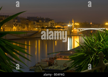 Puente de Isabel II (bridge) across the Rio Guadalquivir (River) to the Triana district at dusk, City of Sevilla Stock Photo