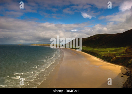 This is a view of Rhossilli Bay looking towards burry holmes on the Gower Peninsula. On the beach is the famous helvetia wreck Stock Photo