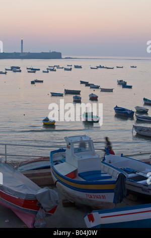 Small boats anchored along Playa de la Caleta (beach) after sunset in the city of Cadiz, Province of Cadiz, Andalusia Stock Photo