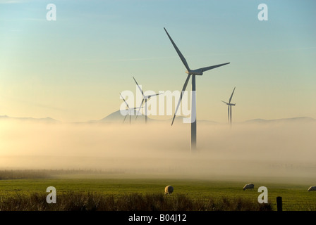 Wind farm emerging from morning mist at Causeymire, Caithness, Scotland, UK Stock Photo