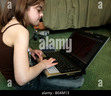 Teen girl using laptop Stock Photo - Alamy