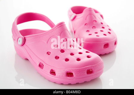Pair of pink rubber crocs. Stock Photo
