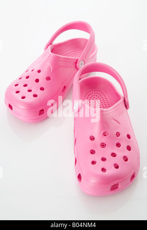 Pair of pink rubber crocs Stock Photo