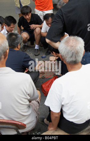 Men Playing Chinese Chess In Muslim District, Xian, China Stock Photo