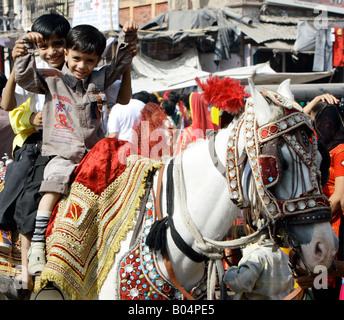 Children riding on decorated pony, Jodhpur, Rajasthan, India Stock Photo