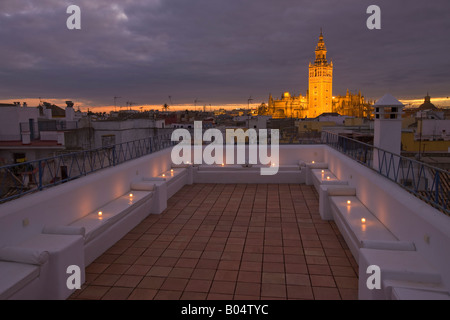 La Giralda and Sevilla Cathedral seen from the terrace at the Banos Arabes (Arab Baths) - Aire de Sevilla at dusk Stock Photo