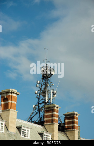 Mobile phone mast on top of a building Stock Photo