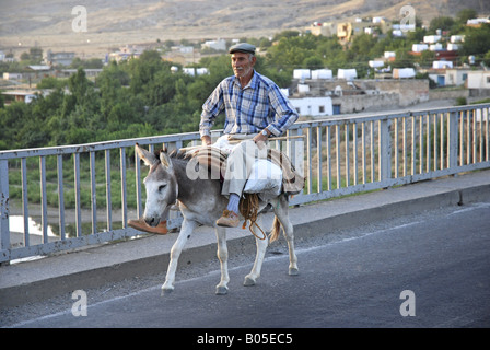 Turkish Man Riding donkey on road in Cappadocia region of Turkey Stock ...
