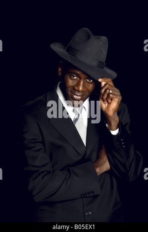 Handsome mid adult african american man in a fine black business suit and Panama hat Stock Photo