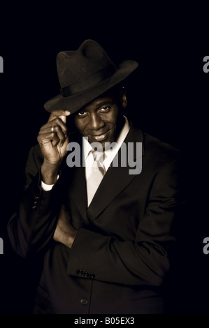Handsome mid adult african american man in a fine black business suit and Panama hat Stock Photo
