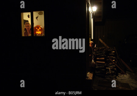 Manitoba Churchill Halloween Jack o Lantern behind kitchen window Stock Photo