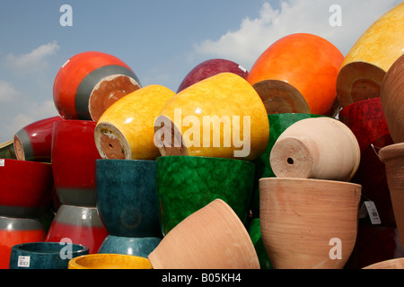 Display of colourful glazed ceramic and terracotta garden pots Stock Photo