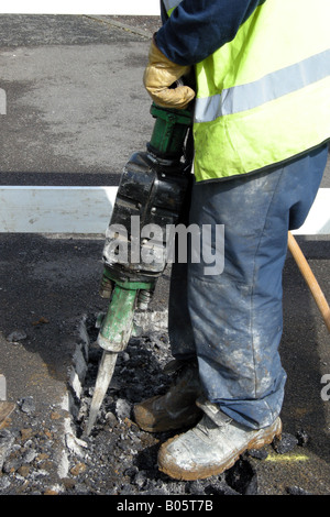 Close up of a workmans hands whilst he uses a Jackhammer showing the possibility of RSI Stock Photo