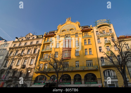 Horizontal wide angle of the amazing Art Nouveau facade of the Grand Hotel Evropa on Wenceslas Square against a bright blue sky. Stock Photo