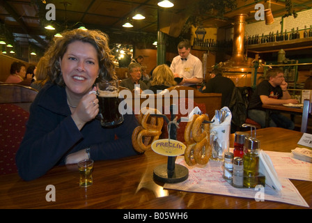 Horizontal wide angle of a tourist enjoying a local beer at a typical traditional Czech beerhall 'Pivovar'. Stock Photo