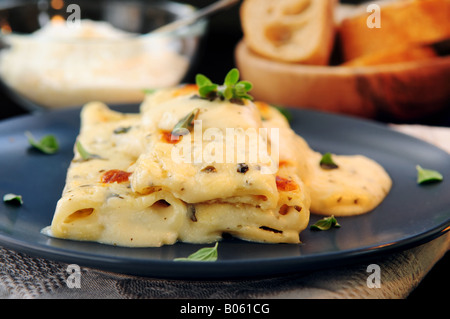 Cheese cannelloni pasta served on a plate with alfredo sauce Stock Photo