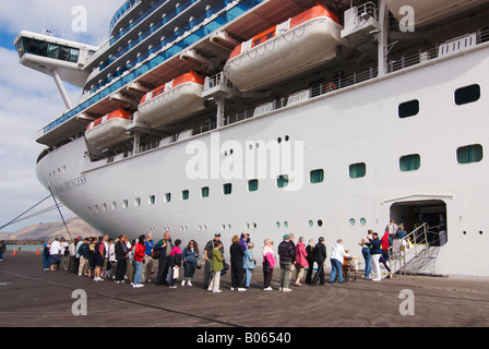 Passengers return to their cruise ship after taking a local day excursion while the ship was in port. Stock Photo