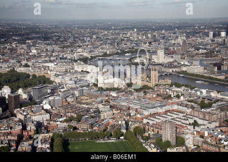 Aerial view north east of inner city buildings Westminster River Thames Houses of Parliament Millennium Wheel London SW1 WC2 Eng Stock Photo