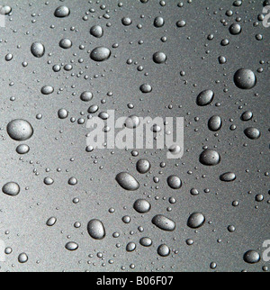 Car Body Panel Covered in Raindrops on Metallic Silver Surface Stock Photo