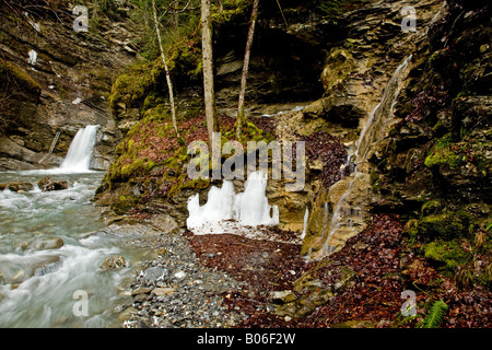 Remnants of ice stacked against a rock outcrop at Nyon Cascade, Morzine, France, EU. Stock Photo