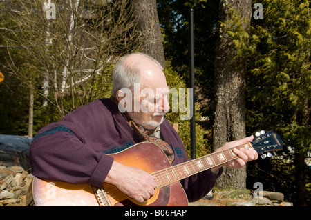 senior playing acoustic guitar Stock Photo