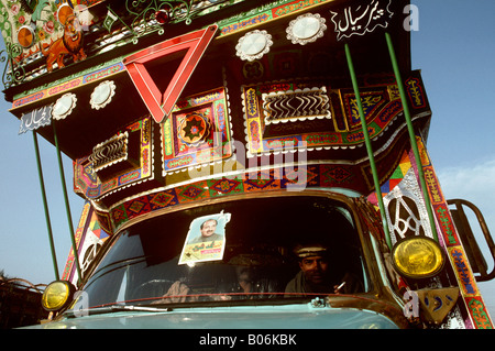 Pakistan Punjab Grand Trunk Road transport men in cab of decorated truck Stock Photo