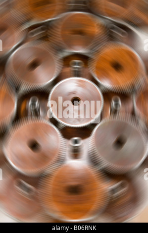 Gears move around a stationary cog wheel with steel teeth Stock Photo