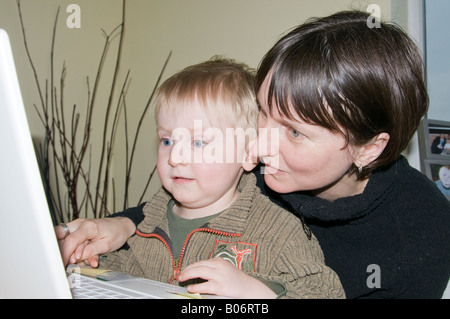 Mother and son using laptop computer Stock Photo