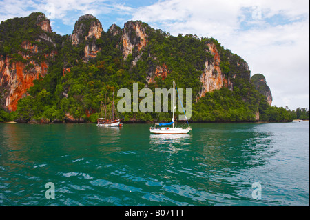 Tropical cliffs with trees rise above waters of Andaman Sea. Krabi, Thailand Stock Photo