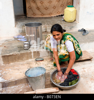 Khajuraho Village: Young Lady Washing Clothes Stock Photo