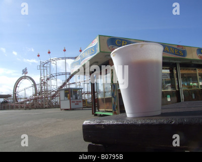 cup of coffee on table at empty  fairground in sun Stock Photo
