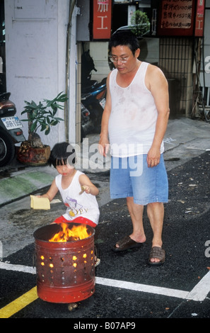 Young Boy Burning Spirit Money During Ghost Month Taiwan Stock Photo