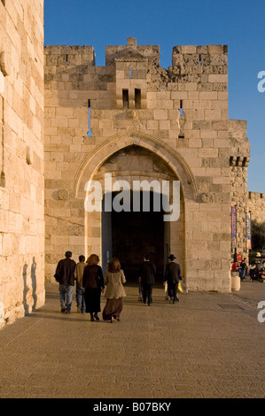 Ultra orthodox jew walk through Jaffa gate or Bab al-Khalil Old city East Jerusalem Israel Stock Photo