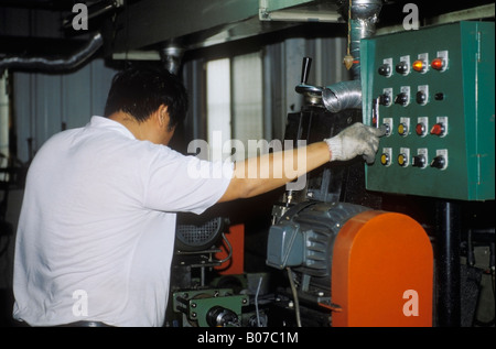 Man Operating Industrial Machine In Bicycle Manufacturing Factory Taiwan Stock Photo