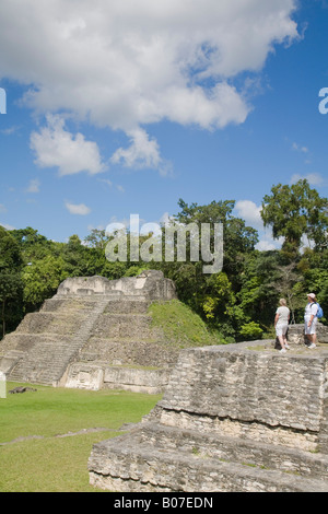Belize, Caracol ruins,  Plaza A, Ladies standing on Structure A6 - Temple of the Wooden Lintel Stock Photo