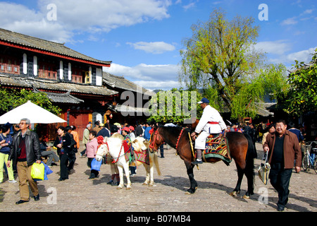 Naxi horseman in the Old Market Square of Lijiang Old Town, in China’s Yunnan Province. Stock Photo