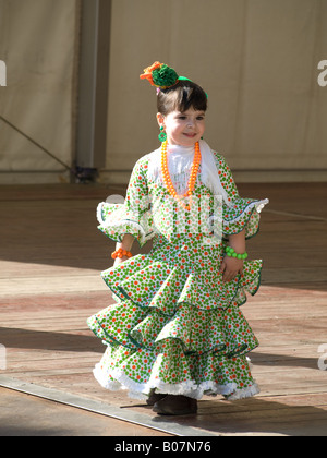 Spanish small girl in traditional Andalusian dress at the April fair in Barcelona Stock Photo