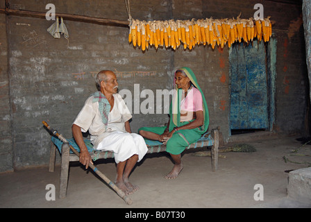 Old couple sitting on a cot, Pawara tribe Stock Photo