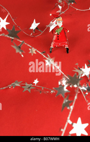 A Santa Claus pin and tinsel Stock Photo
