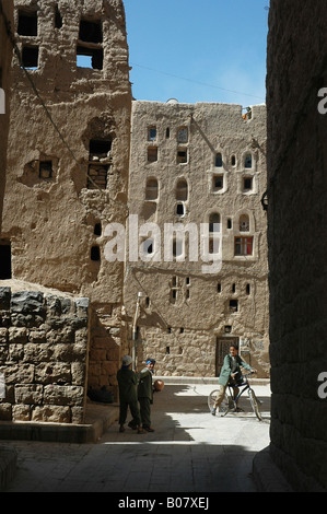 In Amran, an ancient town in Yemen of plain mudbrick and straw buildings, children play in an alley Stock Photo
