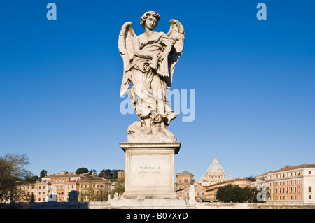 one of the angel statues on sant'angelo bridge in rome. In the background, saint peter's basilica Stock Photo