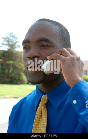 Black businessman communicating on a cellular mobile telephone Stock Photo