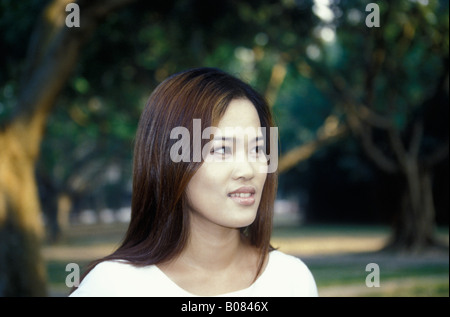 Asian Young Chinese Woman In Park Head and Shoulder Portrait Profile View Stock Photo
