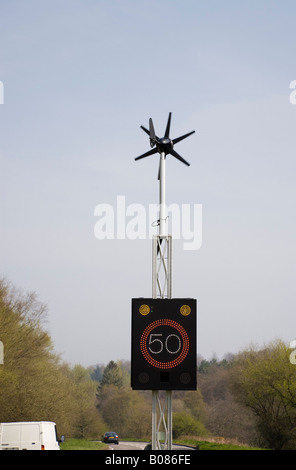 England UK Wind powered 50 mph speed sign illuminated by vehicle on country main road Stock Photo